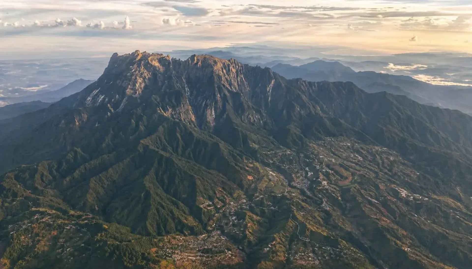 Mount Kinabalu rising above the forested slopes of Kinabalu Park, Sabah